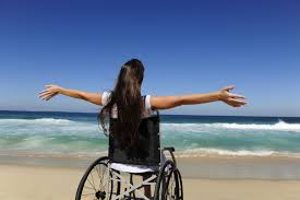 Woman in wheelchair on the beach