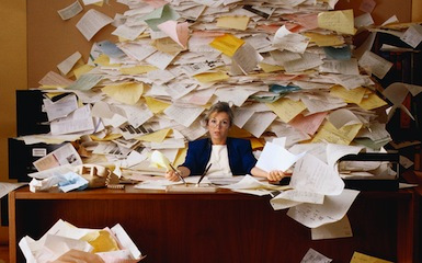 Office Worker with Mountain of Paperwork