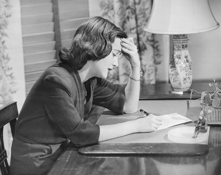 young-woman-writing-letter-at-desk