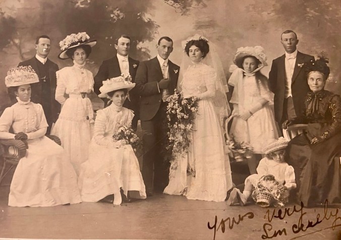 My nana's sisters are the flower girls here, their mother seated on the far left
